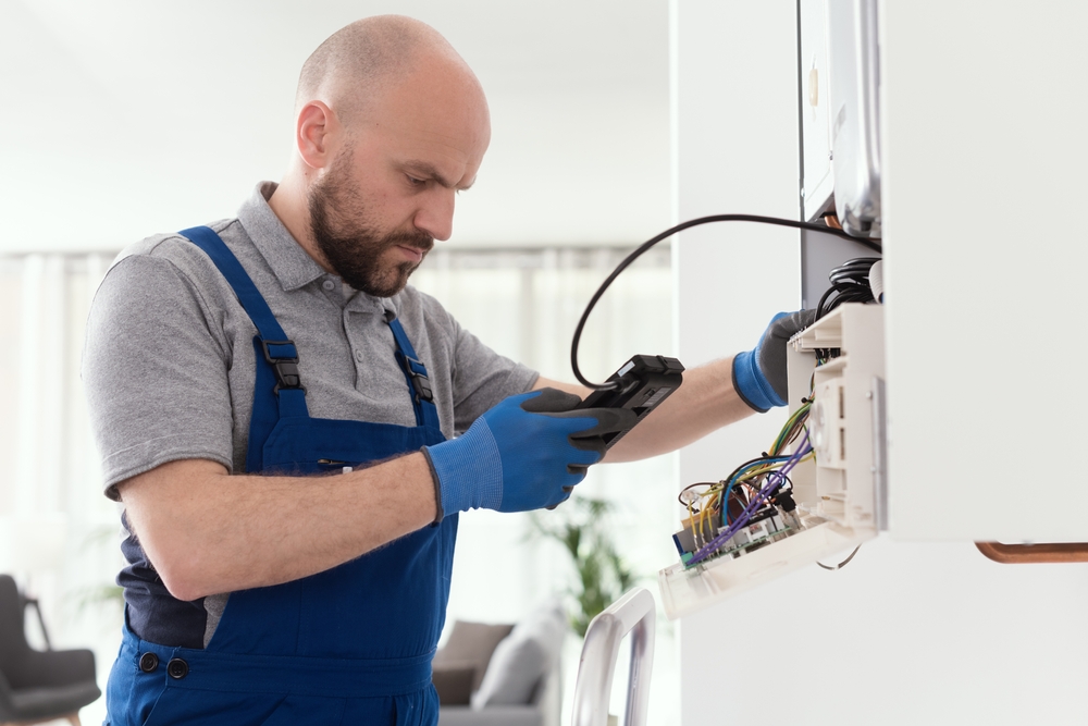 Qualified Engineer Checking Flue Gas missions On A Domestic Gas boiler