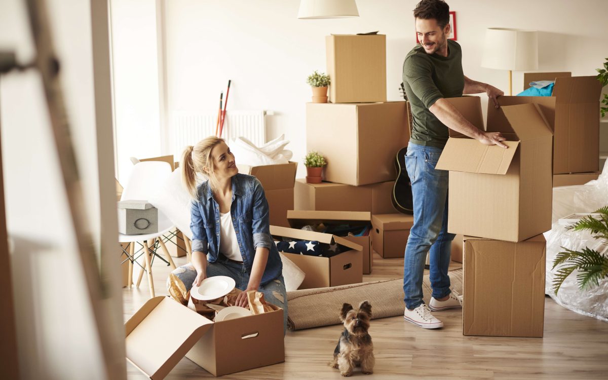 couple unpacking boxes in their new home